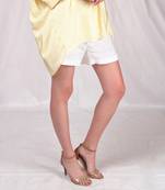 White mid-thigh length shorts.