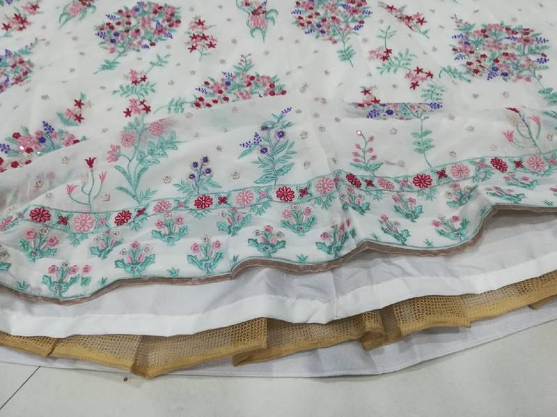 Cream Georgette Thread Embroidered Sleeveless Lehenga Choli With Net Dupatta