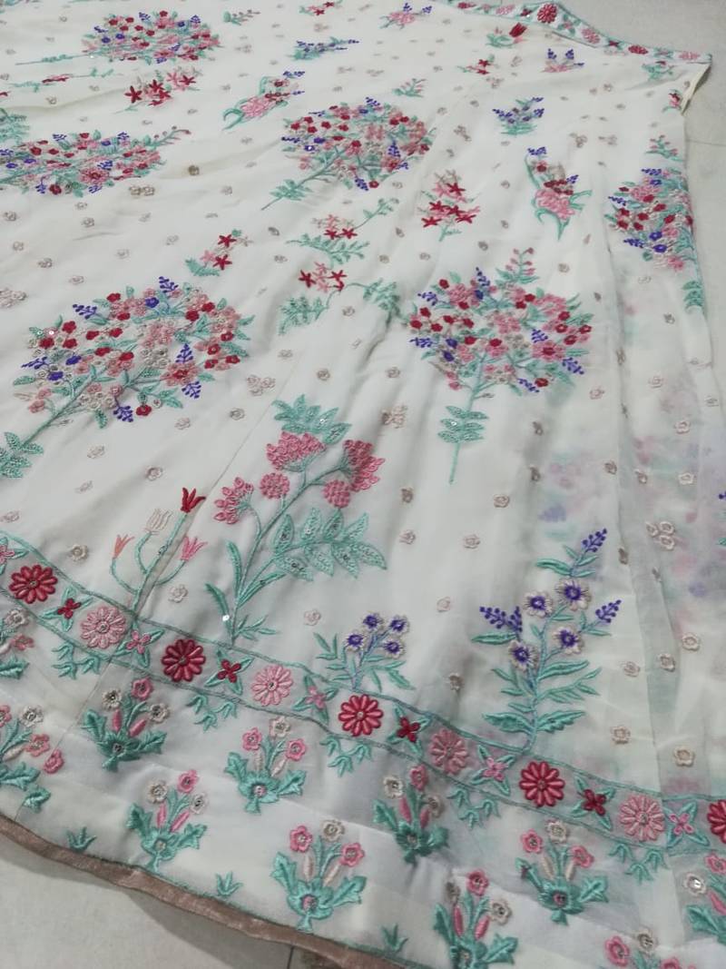 Cream Georgette Thread Embroidered Sleeveless Lehenga Choli With Net Dupatta