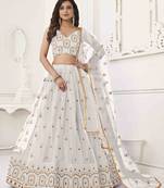 OFF WHITE NET FABRIC LEHENGA CHOLI WITH SEQUINS AND THREAD EMBROIDERY WORK