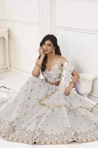 OFF WHITE NET FABRIC LEHENGA CHOLI WITH SEQUINS AND THREAD EMBROIDERY WORK