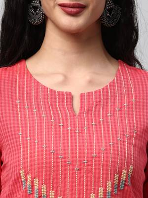 A straight kurta with machine embroidery at the center and sleeve. 5