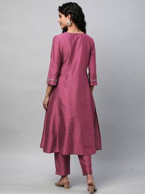 A flared kurta with machine embroidery placement of self light tone. 2
