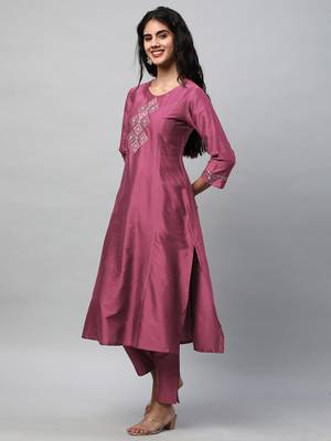 A flared kurta with machine embroidery placement of self light tone. 3