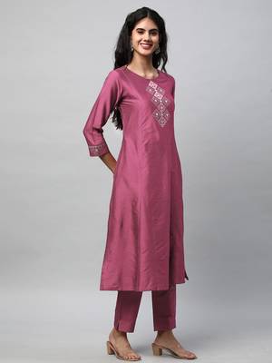 A flared kurta with machine embroidery placement of self light tone. 4