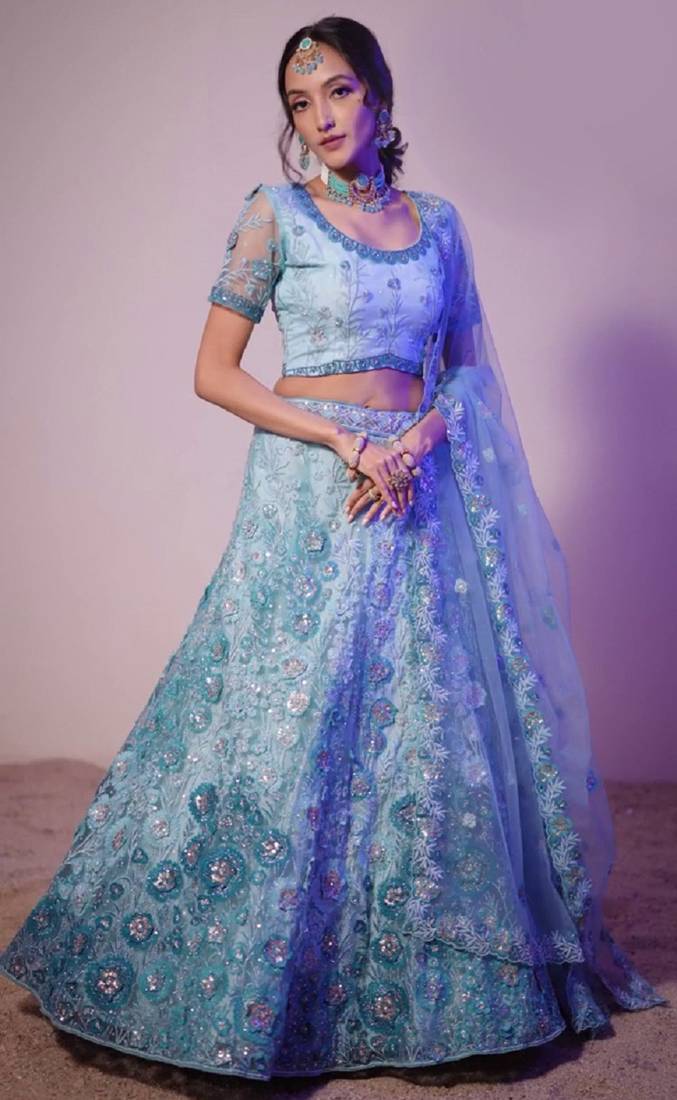 Bewitching Firozi sequins, thread, and zari Embroidered and hand embellished done all over the designer wedding lehenga