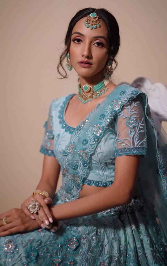 Bewitching Firozi sequins, thread, and zari Embroidered and hand embellished done all over the designer wedding lehenga