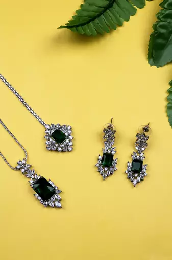 Silver plated green square ad cz studded leaf pendant set with earrings and maangtika