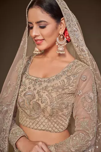  Royal Beige Thread Zari Badla And Glitter Dori Embroidered Net Lehenga Choli For Festival