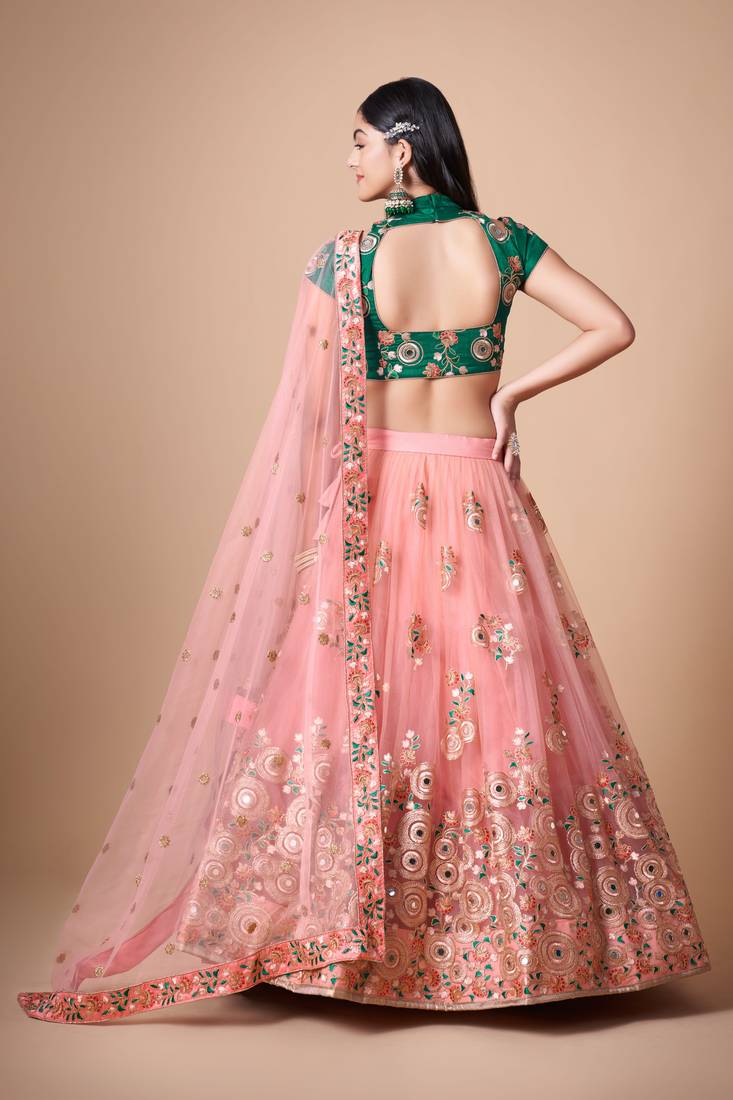 Peach Thread Zari Dori And Sequins Embroidered With Mirror Work Soft Net Lehenga Choli