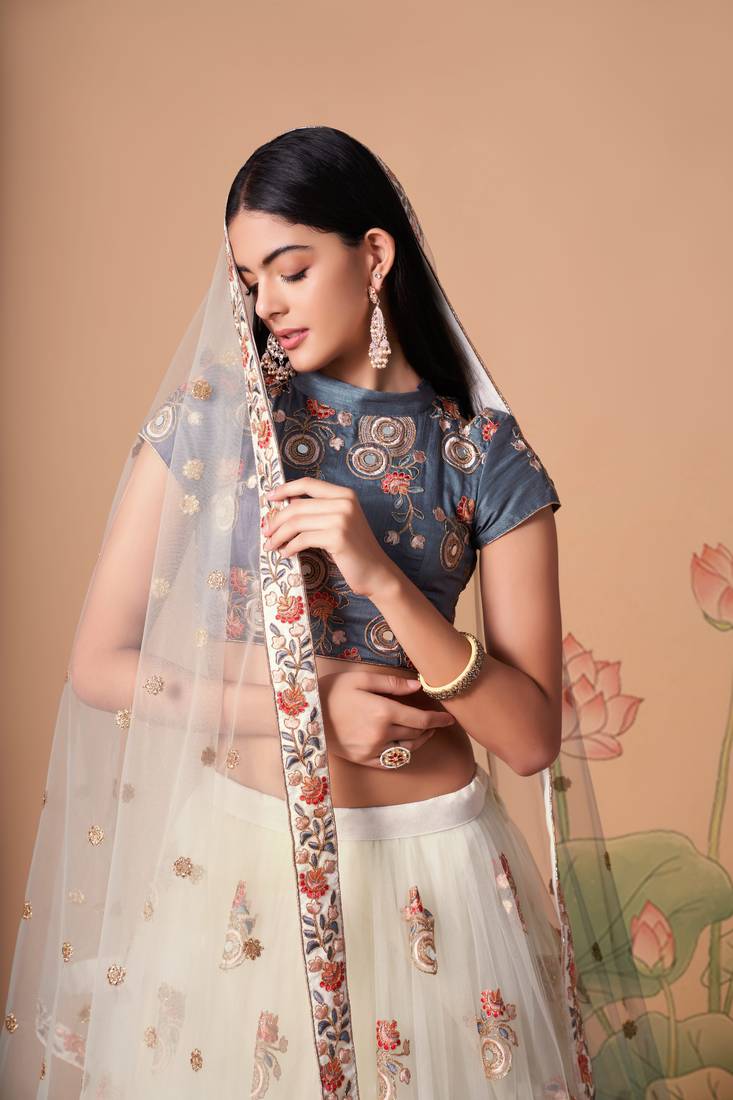 Off White Thread Zari Dori And Sequins Embroidered With Mirror Work Soft Net Designer Lehenga Choli