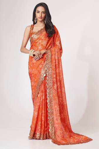 Rich coral-orange gold sequin and zari-style embroidered delicate tonal floral printed indian wedding Saree