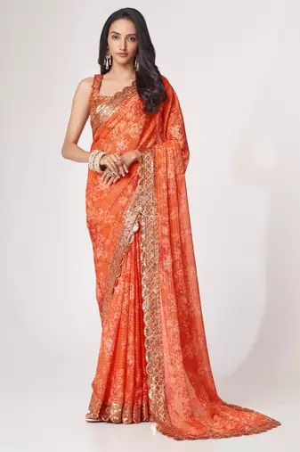Rich coral-orange gold sequin and zari-style embroidered delicate tonal floral printed indian wedding Saree