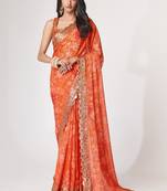 Rich coral-orange gold sequin and zari-style embroidered delicate tonal floral printed indian wedding Saree