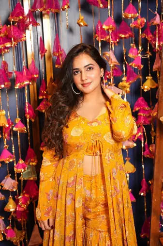 Smart and classy yellow colour crop top dress with sharara and shrug for party looks