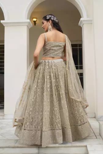 IVORY NET FABRIC LEHENGA CHOLI WITH SEQUINS AND THREAD EMBROIDERY WORK