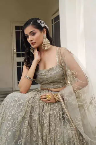 IVORY NET FABRIC LEHENGA CHOLI WITH SEQUINS AND THREAD EMBROIDERY WORK