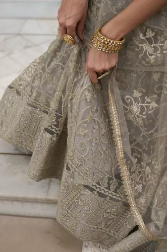 IVORY NET FABRIC LEHENGA CHOLI WITH SEQUINS AND THREAD EMBROIDERY WORK