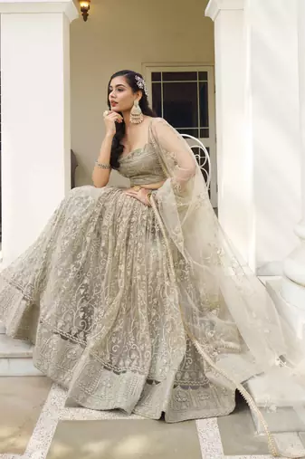 IVORY NET FABRIC LEHENGA CHOLI WITH SEQUINS AND THREAD EMBROIDERY WORK