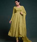A olive green color anarkali suit with lace detailing ,paired with a lightweight matching dupatta.