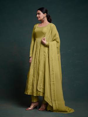 A olive green color anarkali suit with lace detailing ,paired with a lightweight matching dupatta. 2