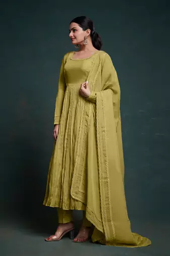 A olive green color anarkali suit with lace detailing ,paired with a lightweight matching dupatta.