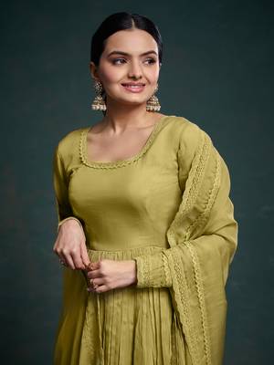 A olive green color anarkali suit with lace detailing ,paired with a lightweight matching dupatta. 3