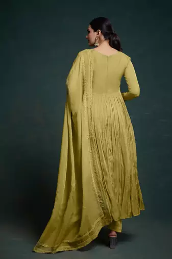 A olive green color anarkali suit with lace detailing ,paired with a lightweight matching dupatta.