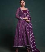 A regal deep purple anarkali dress adorned with a bandhani-inspired pattern and detailed piping along the edges.