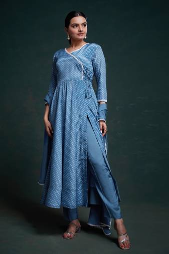 A classic blue polka dot anarkali kurta paired with pants, a flared hemline and detailed lace trim for a timeless look.