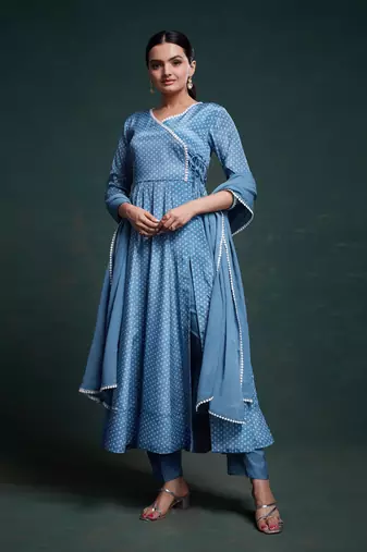 A classic blue polka dot anarkali kurta paired with pants, a flared hemline and detailed lace trim for a timeless look.