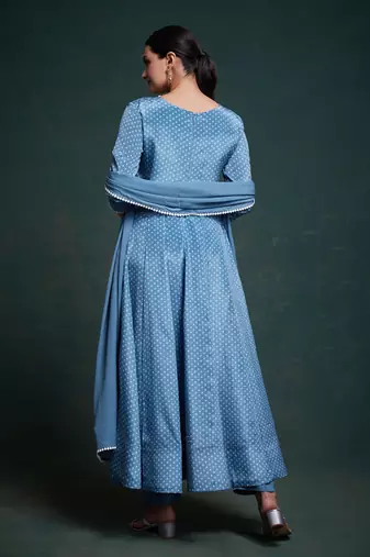 A classic blue polka dot anarkali kurta paired with pants, a flared hemline and detailed lace trim for a timeless look.