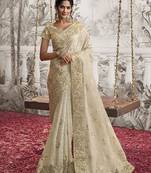 Beige colour crush georgette embroidered saree by monjolika fashion