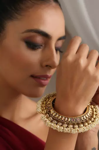 Gold tone pearl temple work kada