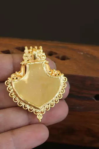 Kerala style gold plated palakka krishna pendant
