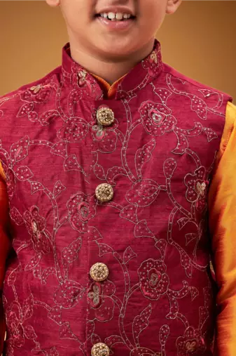 Boy's maroon nehru jacket with orange kurta and pyjama set