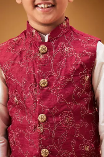 Boy's maroon nehru jacket with cream kurta and pyjama set
