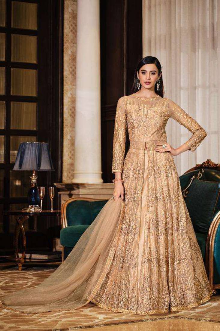 Soft premium net wedding wear semi stitch gown in golden color