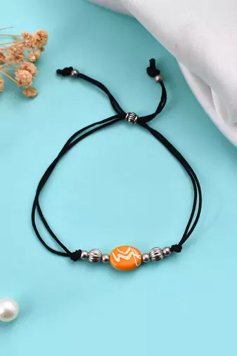 Orange  beeded & charm black threaded  anklet