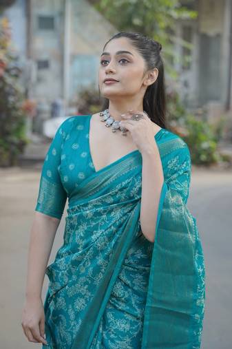 Teal silk blend kalamkari print/floral print golden woven border saree with unstitched blouse piece