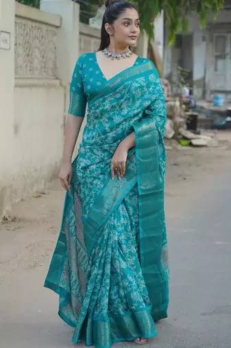 Teal silk blend kalamkari print/floral print golden woven border saree with unstitched blouse piece