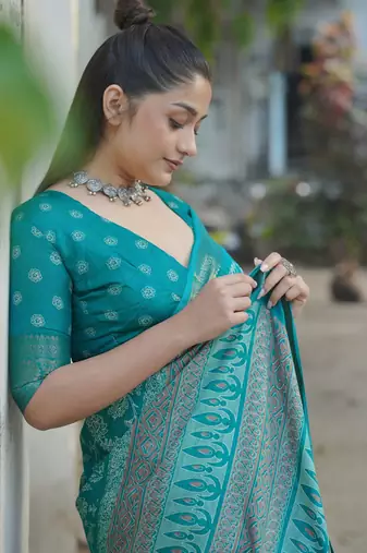 Teal silk blend kalamkari print/floral print golden woven border saree with unstitched blouse piece