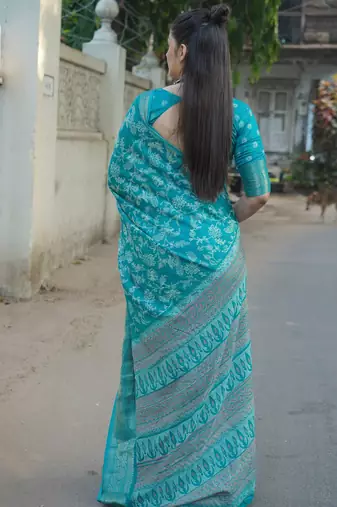 Teal silk blend kalamkari print/floral print golden woven border saree with unstitched blouse piece