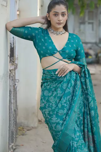 Teal silk blend kalamkari print/floral print golden woven border saree with unstitched blouse piece