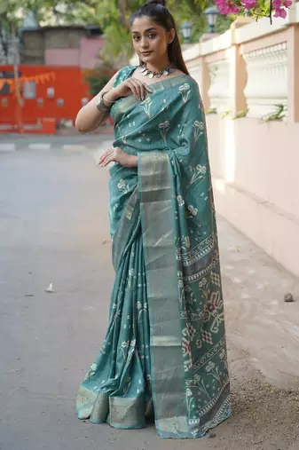 Dusty turquoise silk blend floral print/ikkat print/block print golden woven border saree with unstitched blouse piece