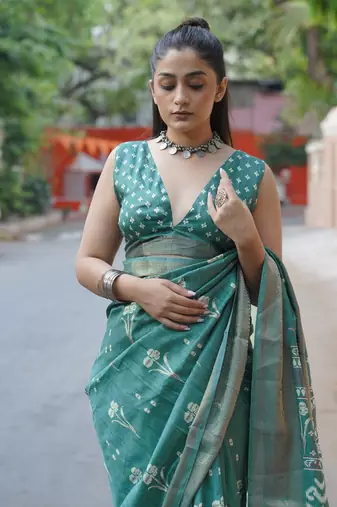 Dusty turquoise silk blend floral print/ikkat print/block print golden woven border saree with unstitched blouse piece