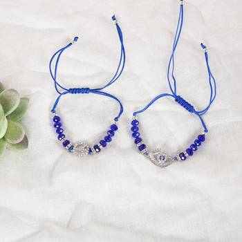  unisex set of 2 blue evil eye rakhi with roli chawal 1