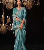 Teal blue colour tissue silk embroidered saree online