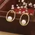 Gold Oval Earrings With Pearl Drop