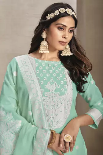 Sober and sophisticated sea green colour organza fabric girlish festive wear ethnic suit